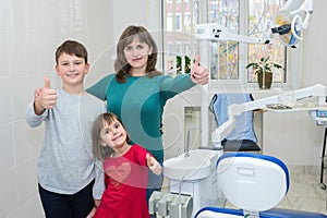 A happy family in a dentistÃ¢â¬â¢s office. Medicine, dentistry and health care photo